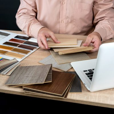 Man,Designer,Is,Holding,Wooden,Laminate,Samples,Of,Different,Colors,